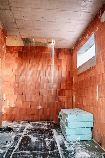 unfinished brick room with water leak from ceiling.