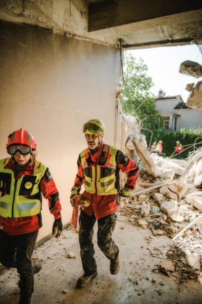 rescuer search trough ruins of building